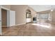 Spacious living room boasting tiled floors, built-in shelving, and a cozy fireplace at 1635 E Silverwood Dr, Phoenix, AZ 85048