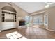 Inviting living room featuring tiled floors, a corner fireplace, and built-in storage at 1635 E Silverwood Dr, Phoenix, AZ 85048