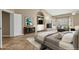 Comfortable main bedroom with a fireplace, television, built-in shelving, and bright light from the window at 1635 E Silverwood Dr, Phoenix, AZ 85048