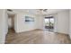 Bright living room featuring hardwood floors, a ceiling fan, and a sliding door leading to a balcony at 16657 E Gunsight Dr # 233, Fountain Hills, AZ 85268