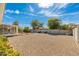 Expansive backyard featuring decorative rock landscaping, mature trees, and a charming enclosed patio at 18034 N 129Th Ave, Sun City West, AZ 85375