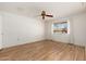 This bedroom features wood-look flooring, a ceiling fan, and a window view at 18034 N 129Th Ave, Sun City West, AZ 85375