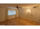 Inviting bedroom with hardwood floors, a ceiling fan, and a neutral color palette, creating a peaceful atmosphere at 18034 N 129Th Ave, Sun City West, AZ 85375