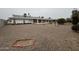 Gravel yard with simple landscaping outlines the exterior of the home at 18034 N 129Th Ave, Sun City West, AZ 85375