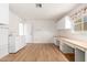 Bright laundry room offering ample cabinetry, wood floors, and a stainless steel sink at 18034 N 129Th Ave, Sun City West, AZ 85375