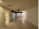 Bright living room with tile flooring, fan, and access to the patio at 18034 N 129Th Ave, Sun City West, AZ 85375