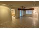 Spacious living room with tile flooring, fan, and access to the dining area at 18034 N 129Th Ave, Sun City West, AZ 85375