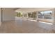 Bright sun room with tile floor and a window-lined view of the landscape at 18034 N 129Th Ave, Sun City West, AZ 85375