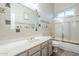 Bathroom featuring a bathtub with a sliding glass door, and a white marble sink and countertop at 1835 E Brookwood Ct, Phoenix, AZ 85048