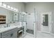 Bright bathroom featuring a glass enclosed shower with stone flooring and a marble vanity with seating at 1835 E Brookwood Ct, Phoenix, AZ 85048