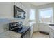 Kitchen boasts white cabinets, granite counters, black appliances, and ample natural light at 1835 E Brookwood Ct, Phoenix, AZ 85048