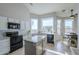 Sunlit kitchen with white cabinets, granite counters, black appliances, and a breakfast nook overlooking backyard at 1835 E Brookwood Ct, Phoenix, AZ 85048