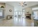 Open-concept living room with a fireplace, tiled floors, and views of the kitchen at 1835 E Brookwood Ct, Phoenix, AZ 85048
