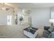 Bright living room featuring a neutral palette, large windows, and carpeted floors at 1835 E Brookwood Ct, Phoenix, AZ 85048