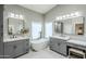Spa-like bathroom with dual sinks, granite countertops, and freestanding soaking tub at 1835 E Brookwood Ct, Phoenix, AZ 85048