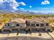 Aerial view of townhomes with desert landscaping and mountain views, showcasing the community's scenic location at 19475 N Grayhawk Dr # 2119, Scottsdale, AZ 85255