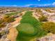 An aerial view displays the meticulous greens and fairways of a local golf course, surrounded by the scenic desert landscape at 19475 N Grayhawk Dr # 2119, Scottsdale, AZ 85255