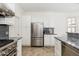 Bright kitchen featuring stainless steel appliances, white cabinets and grey backsplash at 19475 N Grayhawk Dr # 2119, Scottsdale, AZ 85255