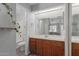 Bright bathroom with vanity, decorative mirror and a full tub and shower at 2035 S Elm St # 217, Tempe, AZ 85282