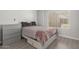 Bright bedroom with a storage bed, dresser, and natural light from the large window at 2035 S Elm St # 217, Tempe, AZ 85282