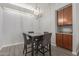 Dining room features an orb light fixture, a brown table with four gray chairs, and wood cabinets at 2035 S Elm St # 217, Tempe, AZ 85282