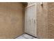 Apartment front door behind a white wrought iron security gate with an off white stucco wall at 2035 S Elm St # 217, Tempe, AZ 85282