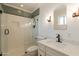 Modern bathroom featuring a walk-in shower with mosaic tile accents, white vanity, and sleek fixtures at 204 E Del Rio Dr, Tempe, AZ 85282