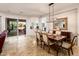 Dining area featuring a large mirror, stylish light fixture, and access to the backyard at 22329 N Padaro Dr, Sun City West, AZ 85375