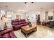 Bright living room with tile floors, leather sofas, and an open floor plan at 22329 N Padaro Dr, Sun City West, AZ 85375