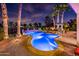 Sparkling pool with elegant patio, palm trees, and inviting outdoor seating area at 22329 N Padaro Dr, Sun City West, AZ 85375