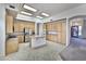 Spacious kitchen with central island, ample wood cabinetry, and modern stainless steel appliances at 22436 N 48Th St, Phoenix, AZ 85054