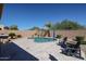 Picture-perfect backyard with a refreshing pool, inviting lounge chairs, desert landscaping, and an outdoor kitchen for ultimate relaxation at 22927 N 41St St, Phoenix, AZ 85050