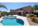Spacious backyard with pool, outdoor kitchen, covered patio, and lush desert landscaping at 22927 N 41St St, Phoenix, AZ 85050