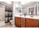 Well-lit bathroom with double vanity, bathtub, toilet and tiled flooring at 22927 N 41St St, Phoenix, AZ 85050