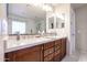 Stylish bathroom featuring double sinks, marble counters, and a luxurious walk-in shower at 22927 N 41St St, Phoenix, AZ 85050