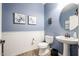 Charming powder room featuring wainscoting, decorative art, and a pedestal sink at 22927 N 41St St, Phoenix, AZ 85050