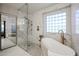 Modern bathroom featuring a glass shower, freestanding tub, and sleek fixtures at 22927 N 41St St, Phoenix, AZ 85050