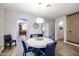 Open dining room area with wood floors, round table and chairs, and modern light fixture at 22927 N 41St St, Phoenix, AZ 85050
