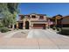 Two-story stucco home featuring a two-car garage, tile roof, arched entry, and landscaped front yard at 22927 N 41St St, Phoenix, AZ 85050