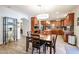 Kitchen with wood cabinets, granite countertops, dining table, and stainless appliances at 22927 N 41St St, Phoenix, AZ 85050