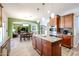 A kitchen boasts an island with granite countertops and opens to the dining and living rooms at 22927 N 41St St, Phoenix, AZ 85050