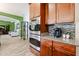Close up of stainless steel double oven with wood cabinets and tiled backsplash at 22927 N 41St St, Phoenix, AZ 85050