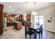 Spacious kitchen with a kitchen island, dining table, and stainless steel appliances at 22927 N 41St St, Phoenix, AZ 85050