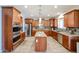 Spacious kitchen with stainless steel appliances, granite countertops, tile backsplash, and wood cabinets at 22927 N 41St St, Phoenix, AZ 85050