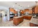 Spacious kitchen with stainless steel appliances, granite countertops, tile backsplash, and wood cabinets at 22927 N 41St St, Phoenix, AZ 85050