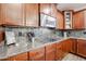 The kitchen has a gas range, granite countertops, and wood cabinets at 22927 N 41St St, Phoenix, AZ 85050