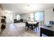 Open floorplan from dining to living spaces with wood floors and lots of natural light at 22927 N 41St St, Phoenix, AZ 85050