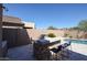 Outdoor kitchen with grill, bar, and view of the pool and backyard at 22927 N 41St St, Phoenix, AZ 85050