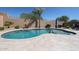 Sparkling pool with stone trim, steps, desert landscaping, mature trees, and privacy wall at 22927 N 41St St, Phoenix, AZ 85050