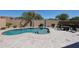 Private swimming pool with travertine surround, palm trees, desert landscaping, and shaded seating area at 22927 N 41St St, Phoenix, AZ 85050
